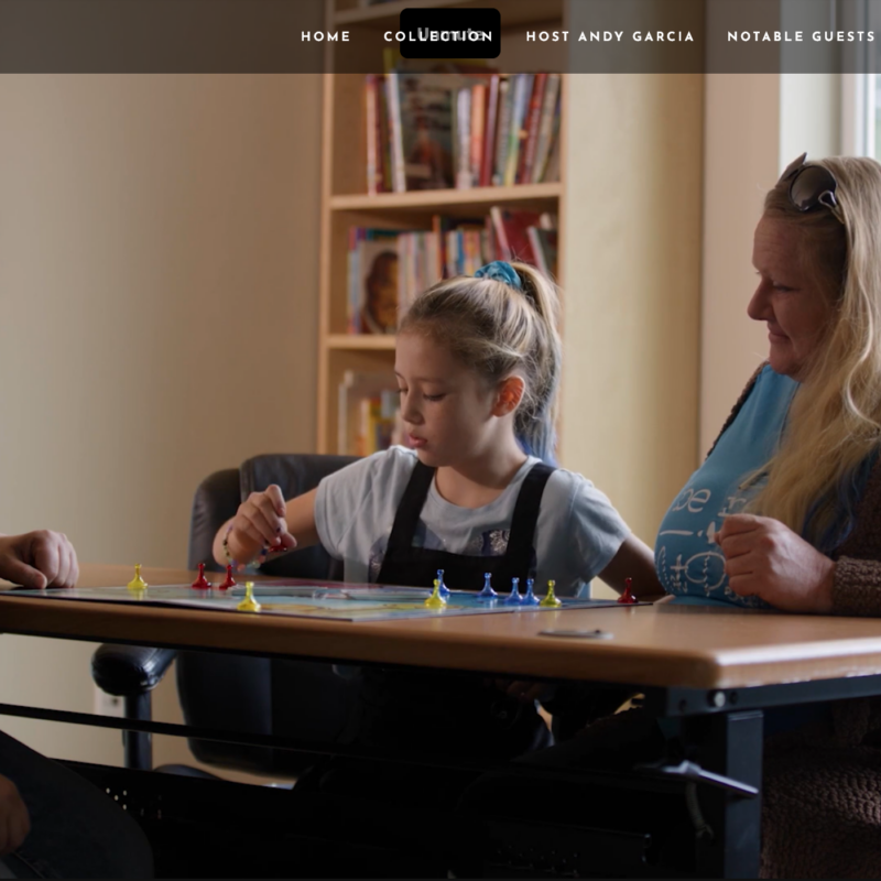 Screenshot of landing page, Kairos video segment on All Access with Andy Garcia. A staff member with a parent and child playing a board game.